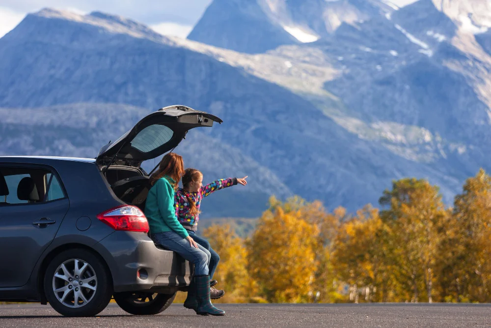 Business traveler with a premium rental car